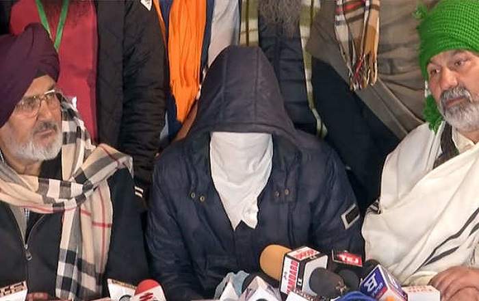 The masked man (C) who was caught by the farmers on Friday night (Image credit: The Economic Times)