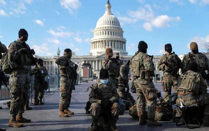 United States National Guard troops gather in front of the US Capitol Hill (Image credit: The Guardian)