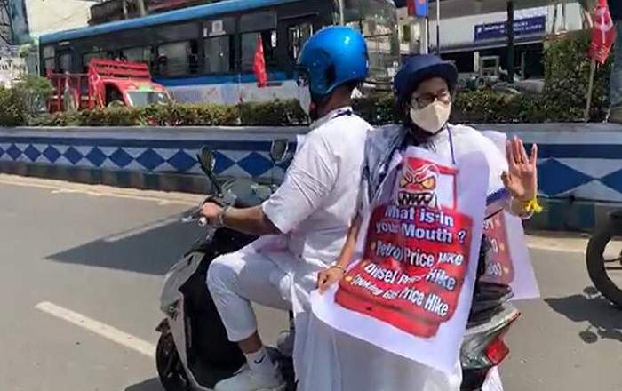 West Bengal CM Mamata Banerjee riding as pillion rider on an Electric scooty in protest against fuel price hike (Image credit: OdishaTV)