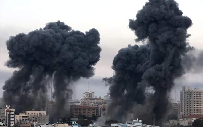 Smoke rises from a Gaza tower after it was hit by Israeli air strikes (Image credit: NDTV)