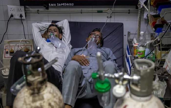 Two corona virus patients sharing a bed in a government hospital in Delhi (Image credit: NDTV)