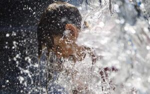 A boy cools off amid scorching heat wave conditions in parts of western North America (Image credit: NDTV)